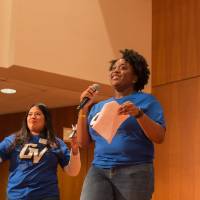 Image of TRIO advisors conducting the raffle. Tshirt is being raffled off